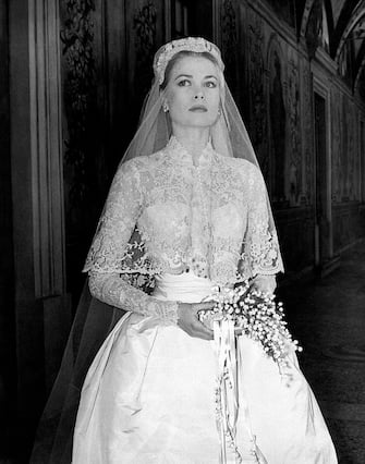 The big movie star Grace Kelly photographed in her bridal dress in a frescoed gallery within the Prince's Palace, just before the wedding ceremony where she will marry Ranier III of Monaco, becoming princess of the Principality. Monaco, April 18th, 1956. (Photo by Mondadori via Getty Images)