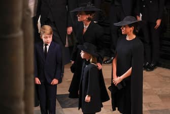 LONDON, ENGLAND - SEPTEMBER 19: Catherine, Princess of Wales, Princess Charlotte of Wales, Prince George of Wales and Meghan, Duchess of Sussex attend Westminster Abbey for the State Funeral of Queen Elizabeth II on September 19, 2022 in London, England.  Elizabeth Alexandra Mary Windsor was born in Bruton Street, Mayfair, London on 21 April 1926. She married Prince Philip in 1947 and ascended the throne of the United Kingdom and Commonwealth on 6 February 1952 after the death of her Father, King George VI. Queen Elizabeth II died at Balmoral Castle in Scotland on September 8, 2022, and is succeeded by her eldest son, King Charles III. (Photo by Phil Noble - WPA Pool/Getty Images)