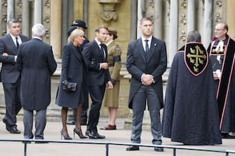 French President Emmanuel Macron (4L) and First Lady Brigitte Macron (3L) arrive at the State Funeral of Queen Elizabeth II, held at Westminster Abbey in London on September 19, 2022. - Leaders from around the world will attend the state funeral of Queen Elizabeth II. The country's longest-serving monarch, who died aged 96 after 70 years on the throne, will be honoured with a state funeral on Monday morning at Westminster Abbey. (Photo by James Manning / POOL / AFP) (Photo by JAMES MANNING/POOL/AFP via Getty Images)