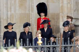 LONDON, ENGLAND - SEPTEMBER 19: Meghan, Duchess of Sussex, Camilla, Queen Consort, Prince George of Wales, Catherine, Princess of Wales, Princess Charlotte of Wales and Sophie, Countess of Wessex are seen during The State Funeral Of Queen Elizabeth II at Westminster Abbey on September 19, 2022 in London, England. Elizabeth Alexandra Mary Windsor was born in Bruton Street, Mayfair, London on 21 April 1926. She married Prince Philip in 1947 and ascended the throne of the United Kingdom and Commonwealth on 6 February 1952 after the death of her Father, King George VI. Queen Elizabeth II died at Balmoral Castle in Scotland on September 8, 2022, and is succeeded by her eldest son, King Charles III.  (Photo by Chris Jackson/Getty Images)