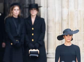 LONDON, ENGLAND - SEPTEMBER 19:  Princess Beatrice of York, Princess Eugenie of York and Meghan, Duchess of Sussex during the State Funeral of Queen Elizabeth II at Westminster Abbey on September 19, 2022 in London, England.  Elizabeth Alexandra Mary Windsor was born in Bruton Street, Mayfair, London on 21 April 1926. She married Prince Philip in 1947 and ascended the throne of the United Kingdom and Commonwealth on 6 February 1952 after the death of her Father, King George VI. Queen Elizabeth II died at Balmoral Castle in Scotland on September 8, 2022, and is succeeded by her eldest son, King Charles III. (Photo by Samir Hussein/WireImage)
