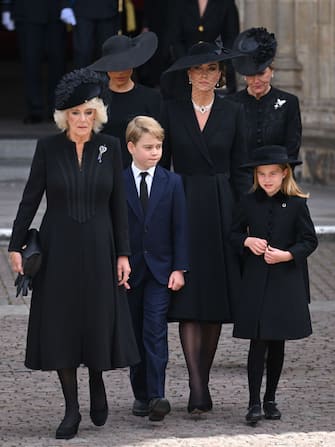 LONDON, ENGLAND - SEPTEMBER 19: (L-R) Camilla, Queen Consort, Meghan, Duchess of Sussex, Prince George of Wales, Catherine, Princess of Wales, Princess Charlotte of Wales and Sophie, Countess of Wessex during the State Funeral of Queen Elizabeth II at Westminster Abbey on September 19, 2022 in London, England. Elizabeth Alexandra Mary Windsor was born in Bruton Street, Mayfair, London on 21 April 1926. She married Prince Philip in 1947 and ascended the throne of the United Kingdom and Commonwealth on 6 February 1952 after the death of her Father, King George VI. Queen Elizabeth II died at Balmoral Castle in Scotland on September 8, 2022, and is succeeded by her eldest son, King Charles III. (Photo by Karwai Tang/WireImage)