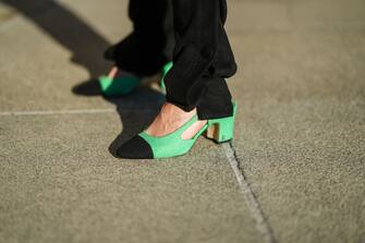 1348851727 PARIS, FRANCE - OCTOBER 19: Natalia Verza wears black cargo pants form Rhodochrosite, green tweed with black pointed toe-cap block heels Slingback ballerinas / shoes from Chanel, on October 19, 2021 in Paris, France. (Photo by Edward Berthelot/Getty Images)