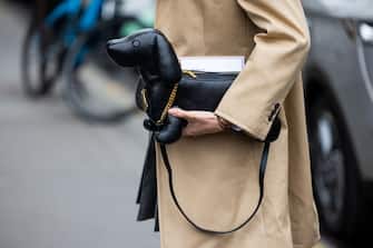 PARIS, FRANCE - OCTOBER 03: Kiwi Lee Han wears black beret, beige blazer, grey pleated skirt, two tone blazer, white socks, heels, tie, dog shaped bag outside Thom Browne during Paris Fashion Week - Womenswear Spring/Summer 2023 : Day Eight on October 03, 2022 in Paris, France. (Photo by Christian Vierig/Getty Images)
