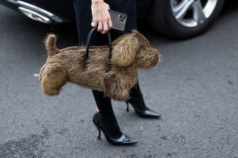 PARIS, FRANCE - OCTOBER 03: A guest wears dog shaped look like bag outside Thom Browne during Paris Fashion Week - Womenswear Spring/Summer 2023 : Day Eight on October 03, 2022 in Paris, France. (Photo by Christian Vierig/Getty Images)