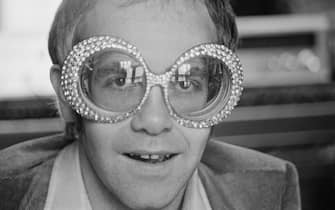 British singer-songwriter Elton John wearing a pair of his flamboyant trademark spectacles, 12th September 1974. (Photo by D. Morrison/Daily Express/Hulton Archive/Getty Images)