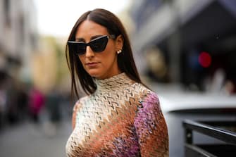 MILAN, ITALY - SEPTEMBER 23: Elisa Taviti wears black sunglasses, a multicolored striped gradient print pattern high neck / long sleeves / long wool tube dress from Missoni, outside Missoni, during the Milan Fashion Week - Womenswear Spring/Summer 2023 on September 23, 2022 in Milan, Italy. (Photo by Edward Berthelot/Getty Images)