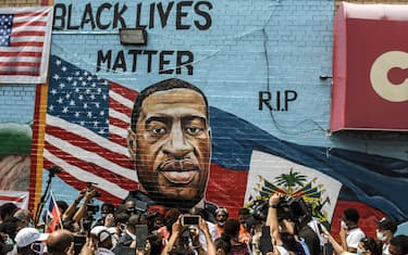 NEW YORK, NY - JULY 13: A mural painted by artist Kenny Altidor depicting George Floyd is unveiled on a sidewall of CTown Supermarket on July 13, 2020 in the Brooklyn borough New York City. George Floyd was killed by a white police officer in Minneapolis and his death has sparked a national reckoning about race and policing in the United States.  (Photo by Stephanie Keith/Getty Images)