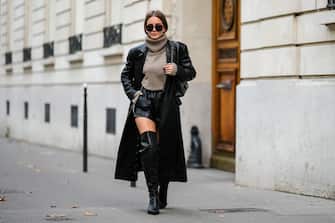 PARIS, FRANCE - OCTOBER 19: Diane Batoukina wears black leather thigh high pointed boots from Mango, a gray wool turtleneck sweater from Massimo Dutti, a long black leather trench coat, black leather shorts from LPA, a black leather quilted Chanel Bag, YSL Saint Laurent sunglasses, during a street style fashion photo session, on October 19, 2022 in Paris, France. (Photo by Edward Berthelot/Getty Images)