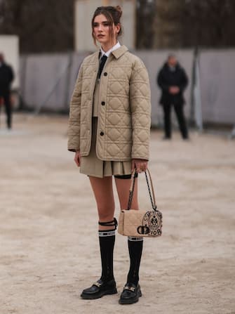 PARIS, FRANCE - MARCH 01: Maria Sharapova seen wearing beige puffer jacket, skirt, jacket, tie, knee high socks, loafers outside Dior during Paris Fashion Week - Womenswear F/W 2022-2023 on March 01, 2022 in Paris, France. (Photo by Jeremy Moeller/Getty Images)