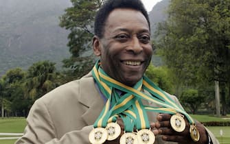 (FILES) In this file photo taken on December 22, 2010 Brazilian football legend Edson Arantes do Nascimento, known as 'Pele', poses with his six Brazil's champion medals during a ceremony in Rio de Janeiro, Brazil.  - Brazilian football icon Pele, widely regarded as the greatest player of all time and a three-time World Cup winner who masterminded the 'beautiful game', died on December 29, 2022 at the age of 82, after battling kidney problems and colon cancer .  (Photo by CAIO LEAL / AFP)