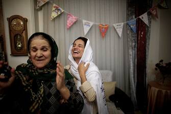 Iranian lawyer Nasrin Sotoudeh smiles after hugging her mother-in-law at her home in Tehran on September 18, 2013, following her release from three years in prison. Sotoudeh told AFP she was in "good" physical and psychological condition, and pledged to continue her human rights work.  Her release came a week before Irans new moderate President Hassan Rowhani, who has promised more freedoms at home and constructive engagement with the world, travels to New York to attend the United Nations General Assembly.  AFP PHOTO/BEHROUZ MEHRI        (Photo credit should read BEHROUZ MEHRI/AFP via Getty Images)
