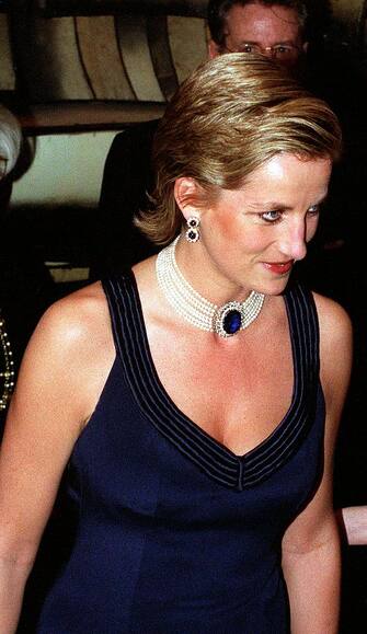 50379733 England's Princess Diana in a new sleek hairstyle, jeweled choker & earrings & navy blue strapped gown at a charity gala dinner at the Lincoln Center for the Performing Arts. (Photo by Ken Goff/Getty Images)