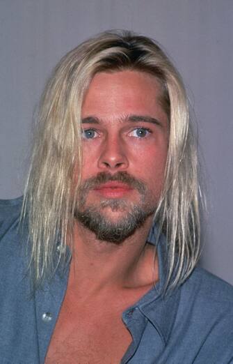 3239908 circa 1991: Headshot of American actor Brad Pitt with long, dyed blonde hair, wearing an open collared blue shirt. (Photo by Frank Edwards/Fotos International/Getty Images)