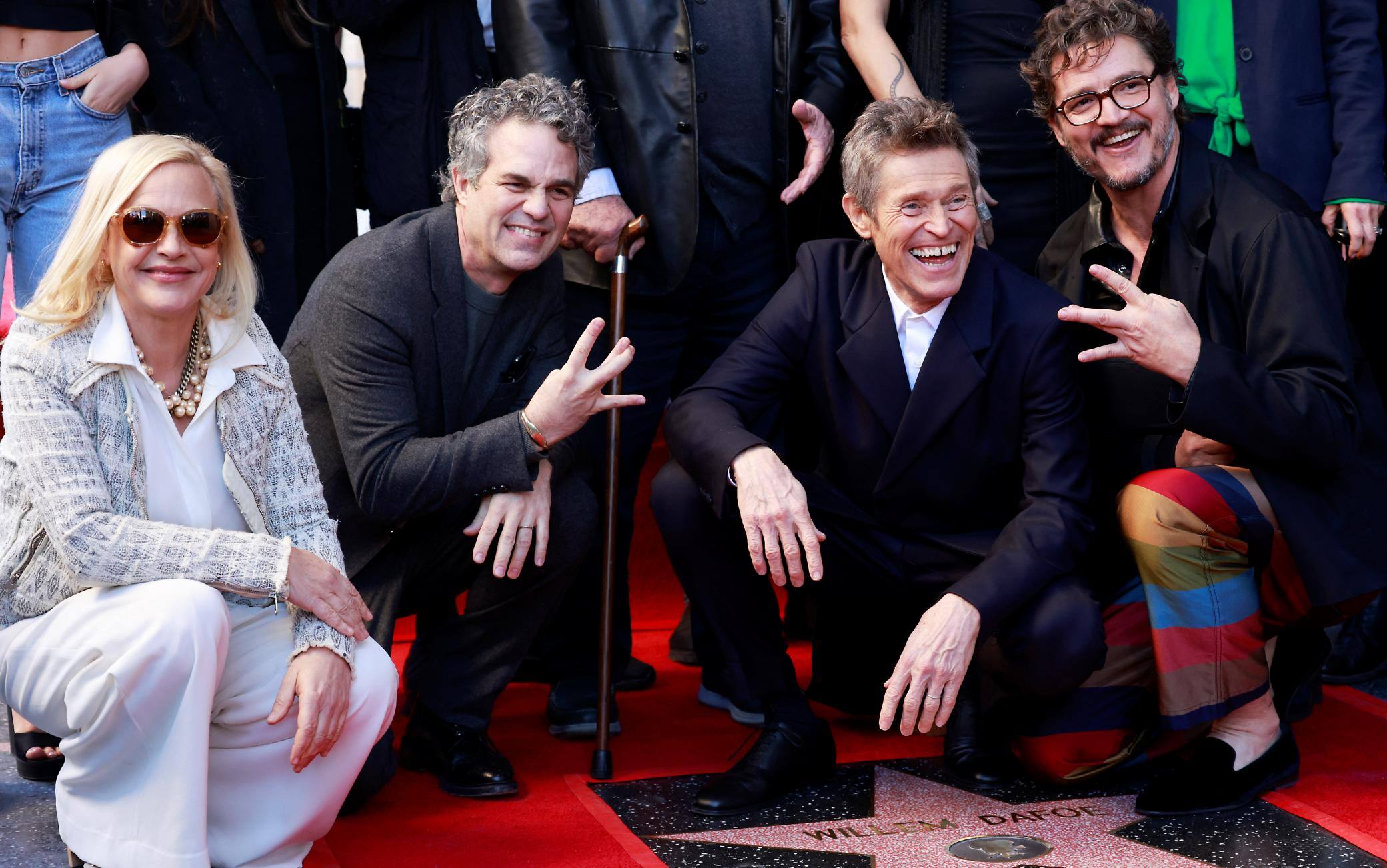 US actress Patricia Arquette (L), US actor Mark Ruffalo (2nd L) and Chilean-US actor Pedro Pascal (R) pose with US actor Willem Dafoe during the ceremony honoring him with a Hollywood Walk of Fame star in Hollywood, California, on January 8, 2024. (Photo by Michael Tran / AFP)