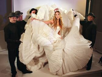 1220416642 A model presents an ecru tulle ball gown with a skirt worked in tulle and cellophane layered cabbage leaves designed by John Galliano for the 1999 Spring/Summer haute couture collection of the Christian Dior fashion house in Paris 18 January. (Photo by Eric Feferberg / AFP) (Photo by ERIC FEFERBERG/AFP via Getty Images)