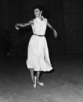 (Original Caption) 8/27/1955-Rome, Italy- Audrey Hepburn, whose many talents didn't include the gavotte, takes lessons in the old French dance in Rome. Audrey had to learn the dance, which was in vogue in czarist Russia, for her role in "War and Peace." No one could be found in Rome who could teach Miss Hepburn the intricate steps of the gavotte until an American dancer from Paris showed up. Under his guidance, Audrey was soon gavotting like best of them.