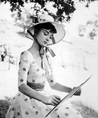 Portrait of Belgian-born American actress Audrey Hepburn (1929 - 1993) as she wears a bonnet and sketches on the set of 'War and Peace' directed by King Vidor, 1956. (Photo by Phil Burchman/Getty Images)