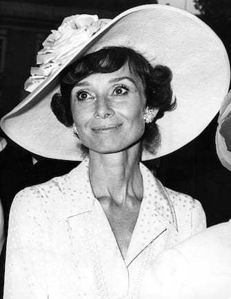 9th October 1973:  Film actress Audrey Hepburn (1929 - 1993), resplendant in wide-brimmed hat, attends a wedding.  (Photo by Keystone/Getty Images)