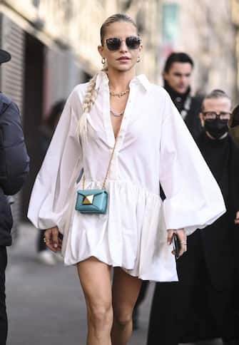 PARIS, FRANCE - MARCH 06: Caroline Daur is seen wearing a white Valentino shirt dress, pink shoes with Valentino bag outside the Valentino show during Paris Fashion Week A/W 2022 on March 06, 2022 in Paris, France. (Photo by Daniel Zuchnik/Getty Images)