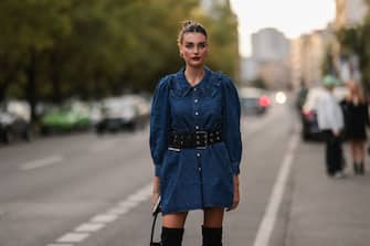 BERLIN, GERMANY - SEPTEMBER 13: Celine Bethmann wearing a jeans dress, a black bag and black overknee boots on September 13, 2021 in Berlin, Germany. (Photo by Jeremy Moeller/Getty Images)