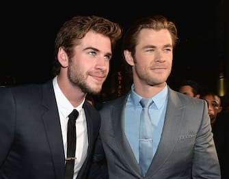 186903531 HOLLYWOOD, CA - NOVEMBER 04: Actors Liam Hemsworth (L) and Chris Hemsworth attend Marvel's "Thor: The Dark World" Premiere at the El Capitan Theatre on November 4, 2013 in Hollywood, California. (Photo by Alberto E. Rodriguez/WireImage)