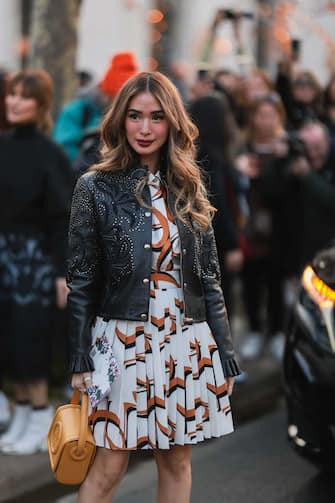 PARIS, FRANCE - MARCH 05: Heart Evangelista seen wearing black leather jacket, pleated skirt & button shirt with brown graphic print, yellow bag outside Elie Saab during Paris Fashion Week - Womenswear F / W 2022-2023 on March 05, 2022 in Paris, France.  (Photo by Jeremy Moeller / Getty Images)