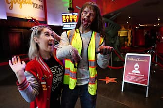 NEW YORK, NEW YORK - OCTOBER 31: A person poses with a zombie figure at Madame Tussauds on October 31, 2020 in New York City. Many Halloween events have been canceled or adjusted with additional safety measures due to the ongoing coronavirus (COVID-19) pandemic. (Photo by Cindy Ord/Getty Images)