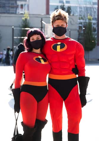 NEW YORK, NEW YORK - OCTOBER 31: People wear costumes of Elastigirl and Mr. Incredible from the The Incredibles in Crown Heights on October 31, 2020 in New York City. Many Halloween events have been canceled or adjusted with additional safety measures due to the ongoing coronavirus (COVID-19) pandemic. (Photo by Noam Galai/Getty Images)
