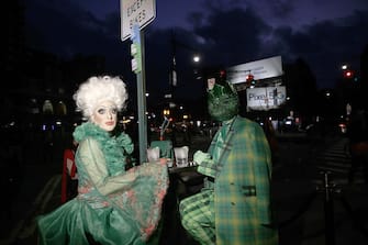 NEW YORK, NEW YORK - OCTOBER 31: People dressed in Halloween costumes sit at an outdoor restaurant in The West Village on October 31, 2020 in New York City. (Photo by John Lamparski/Getty Images)