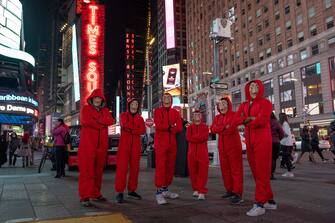 NEW YORK, NEW YORK - OCTOBER 31: People wearing Money Heist costumes pose in Times Square on October 31, 2020 in New York City. Many Halloween events have been canceled or adjusted with additional safety measures due to the ongoing coronavirus (COVID-19) pandemic. (Photo by Alexi Rosenfeld/Getty Images)