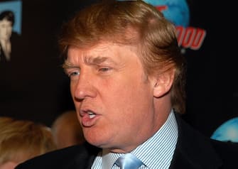 NEW YORK - JANUARY 29:  Donald Trump speaks to reporters as he arrives at "The Apprentice" viewing party on January 29, 2004 at Planet Hollywood, in New York City. (Photo by Gregorio Binuya/Getty Images)