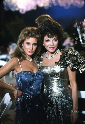 LOS ANGELES - JANUARY 1984: Actresses Joan Collins who plays Alexis (rt) and Pamela Bellwood, who plays Cludia, on the set of the 1980s television hit show soap opera "Dynasty" circa 1984:(Photo by Nik Wheeler/Corbis via Getty Images)
