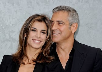 Elisabetta Canalis and George Clooney attend the Giorgio Armani Spring/Summer 2011 fashion show during Milan Fashion Week Womenswear on September 27, 2010 in Milan, Italy.