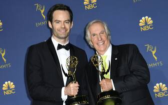 TOPSHOT - Outstanding Lead Actor in a Comedy Series Bill Hader (L) and Outstanding Supporting Actor in a Comedy Series Henry Winkler pose with their trophies during the 70th Emmy Awards at the Microsoft Theatre in Los Angeles, California on September 17, 2018. (Photo by VALERIE MACON / AFP) (Photo by VALERIE MACON/AFP via Getty Images)