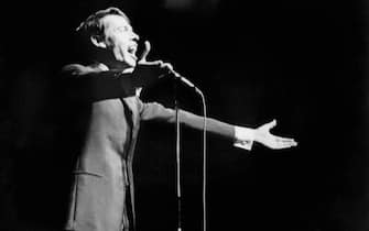 (FILES) - This file photo dated 07 October 1966 shows Belgian singer Jacques Brel singing for during his last show at Olympia music-hall in Paris. Jacques Brel died from a cancer 25 years ago, 09 October 1978 .    AFP PHOTO  (Photo credit should read -/AFP via Getty Images)