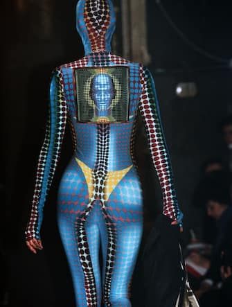 A model presents a Jean-Paul Gaultier's creation, a synthetic combinaison inspired by Vasarely, during the ready-to-wear Fall/Winter 1995/1996 collection fashion show, on March 17, 1995 in Paris. (Photo by Pierre VERDY / AFP) (Photo by PIERRE VERDY/AFP via Getty Images)