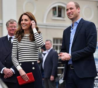 Britain's Catherine, Duchess of Cambridge (C) and Britain's Prince William, Duke of Cambridge (R) react as they look towards the Cutty Sark, as they arrive to launch the King's Cup Regatta, at the Cutty Sark in Greenwich, south east London on May 7, 2019. - The event is set to take place on August 9, 2019, on the Isle of Wight, and is set to see The Duke and Duchess go head to head as skippers of individual sailing boats, in an eight boat regatta race. Each boat taking part will represent one of eight charities and the winning team will be awarded the historic trophy The King's Cup. (Photo by Ben STANSALL / various sources / AFP)        (Photo credit should read BEN STANSALL/AFP via Getty Images)