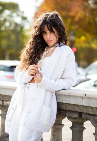 PARIS, FRANCE - SEPTEMBER 27: American singer Camila Cabello is seen wearing total look Izaak Azanei white pants, cardigan, necklace, cropped top during Paris Fashion Week Womenswear Spring Summer 2020 on September 27, 2019 in Paris, France. (Photo by Christian Vierig/GC Images)