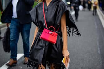 PARIS, FRANCE - OCTOBER 02: Xenia Adonts seen wearing red Hermes bag, black cape outside Hermes during Paris Fashion Week - Womenswear Spring Summer 2022 on October 02, 2021 in Paris, France.  (Photo by Christian Vierig / Getty Images)