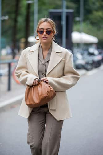 MILAN, ITALY - SEPTEMBER 25: A guest is seen wearing grey pants and button shirt, beige blazer, brown bag outside Sportmax during the Milan Women's Fashion Week on September 25, 2020 in Milan, Italy. (Photo by Christian Vierig/Getty Images)