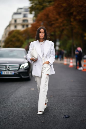 PARIS, FRANCE - SEPTEMBER 25: Alexandra Guerain wears earrings, a necklace, a white top, a white jacket, a white puff bag, white ripped pants, white shoes, outside Margiela, during Paris Fashion Week - Womenswear Spring Summer 2020, on September 25, 2019 in Paris, France. (Photo by Edward Berthelot/Getty Images)