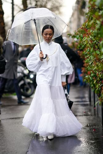 PARIS, FRANCE - MARCH 01: Yoyo Cao wears a white dress/shirt with puff sleeves, a mesh bottom ruffled and pleated part, mandarin collar, a turtleneck wool pullover, a golden necklace, golden earrings, outside Valentino, during Paris Fashion Week - Womenswear Fall/Winter 2020/2021, on March 01, 2020 in Paris, France. (Photo by Edward Berthelot/Getty Images)