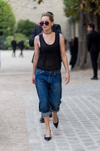 PARIS, FRANCE - SEPTEMBER 30: Actress Jennifer Lawrence wears a sheer top, cropped denim jeans and pointed flats outside of Dior on September 30, 2016 in Paris, France. (Photo by Christian Vierig/Getty Images)