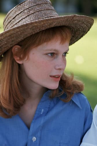 1969:  Headshot of American actor Mia Farrow wearing a straw hat and blue shirt outdoors.  (Photo by Santi Visalli Inc./Getty Images)