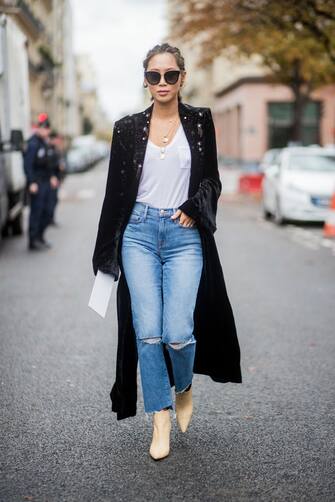 PARIS, FRANCE - OCTOBER 02: Aimee Song with braids hair, wearing denim jeans, black coat seen outside Sacai during Paris Fashion Week Spring/Summer 2018 on October 2, 2017 in Paris, France. (Photo by Christian Vierig/Getty Images)