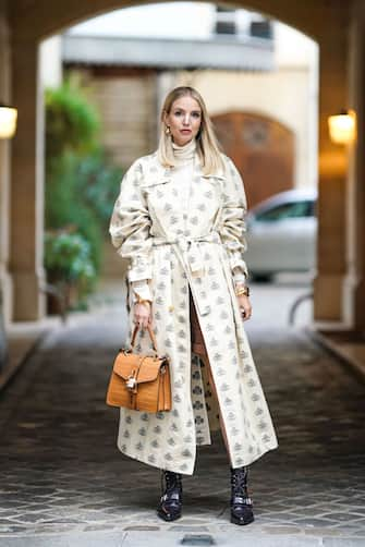 PARIS, FRANCE - OCTOBER 15: Leonie Hanne wears a white trench coat with printed monograms logos, a Chloe brown leather crocodile pattern bag with a padlock, golden bracelet, leather pointy shoes, a white turtleneck top, earrings, in the streets of Paris, on October 15, 2019 in Paris, France. (Photo by Edward Berthelot/Getty Images)