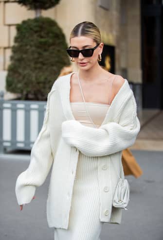 PARIS, FRANCE - FEBRUARY 27: Hailey Bieber is seen wearing creme white cardigan, knitted skirt and top, Bottega bag during Paris Fashion Week Womenswear Fall/Winter 2020/2021 : Day Four on February 27, 2020 in Paris, France. (Photo by Christian Vierig/GC Images)