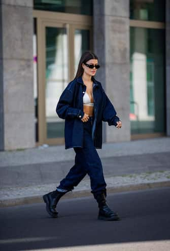 BERLIN, GERMANY - JUNE 22: Enna is seen wearing denim suit jacket and jeans NA-KD, Prada sunglasses, Bottega Veneta boots, white cropped top Prada on June 22, 2021 in Berlin, Germany. (Photo by Christian Vierig/Getty Images)