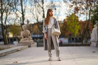 PARIS, FRANCE - NOVEMBER 14: Bertille Canat wears a white turtleneck top from American Vintage, a gray long oversized wool coat from American Vintage, a white large leather bag from Polene, gray pants from American Vintage, Adidas sneakers shoes, on November 14, 2020 in Paris, France. (Photo by Edward Berthelot/Getty Images)